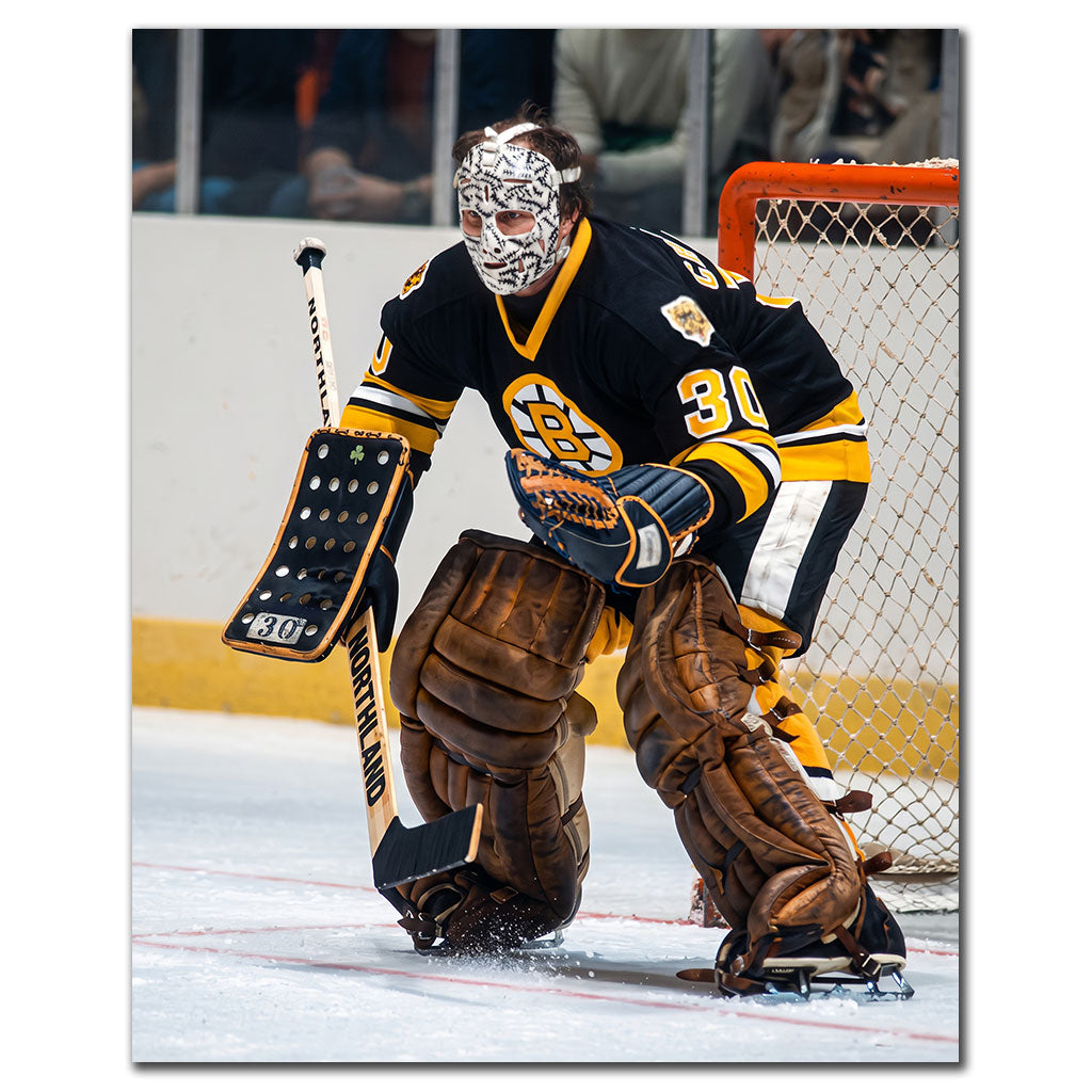 Gerry Cheevers Boston Bruins 8x10 hockey photo wearing his stitched goalie mask and black uniform while standing beside the net for autograph pre-order