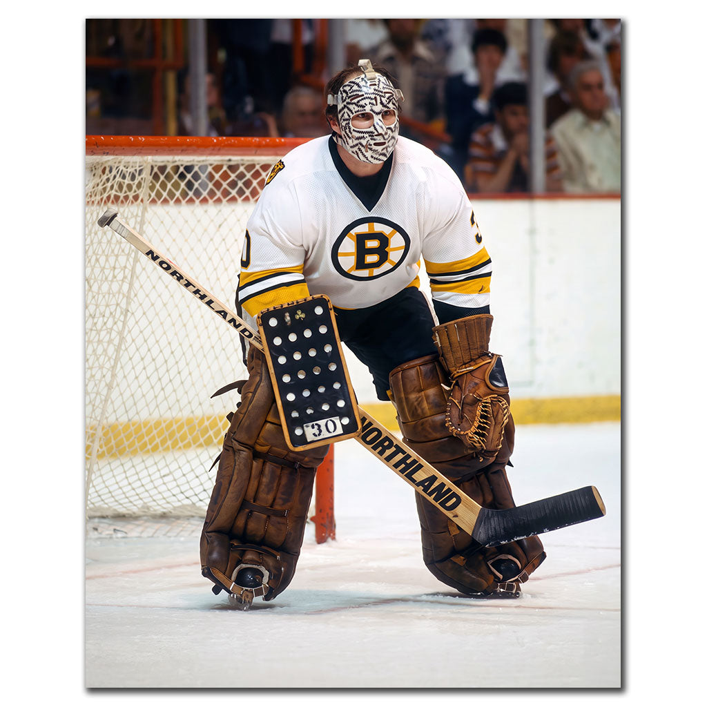 Gerry Cheevers Boston Bruins 8x10 hockey photo wearing his stitched goalie mask and black uniform while standing beside the net for autograph pre-order