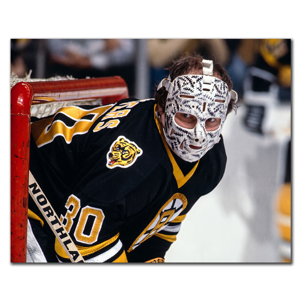 Close-up Gerry Cheevers Boston Bruins 8x10 hockey photo wearing his stitched goalie mask and black uniform beside the goalpost for autograph pre-order