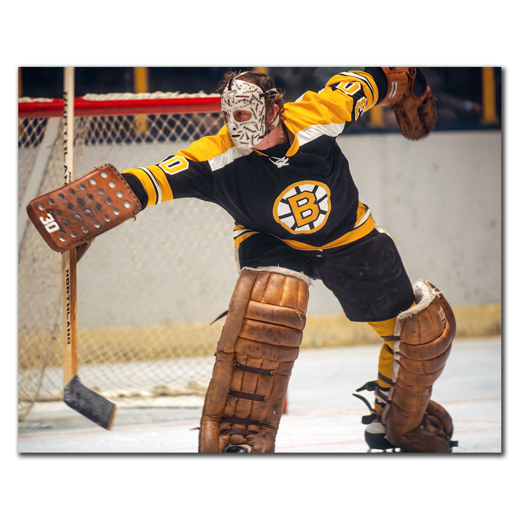 Gerry Cheevers Boston Bruins 8x10 hockey photo wearing his stitched goalie mask and black uniform while extending his blocker for autograph pre-order