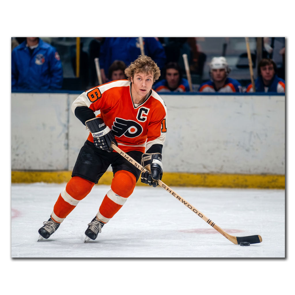 Bobby Clarke signed 8x10 photo in Philadelphia Flyers orange uniform, skating with the puck—perfect addition to Philadelphia Flyers memorabilia.