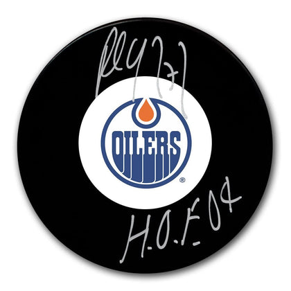 Paul Coffey Edmonton Oilers HOF Signed Puck—black hockey puck autographed in silver marker with Hall of Fame 2004 inscription.