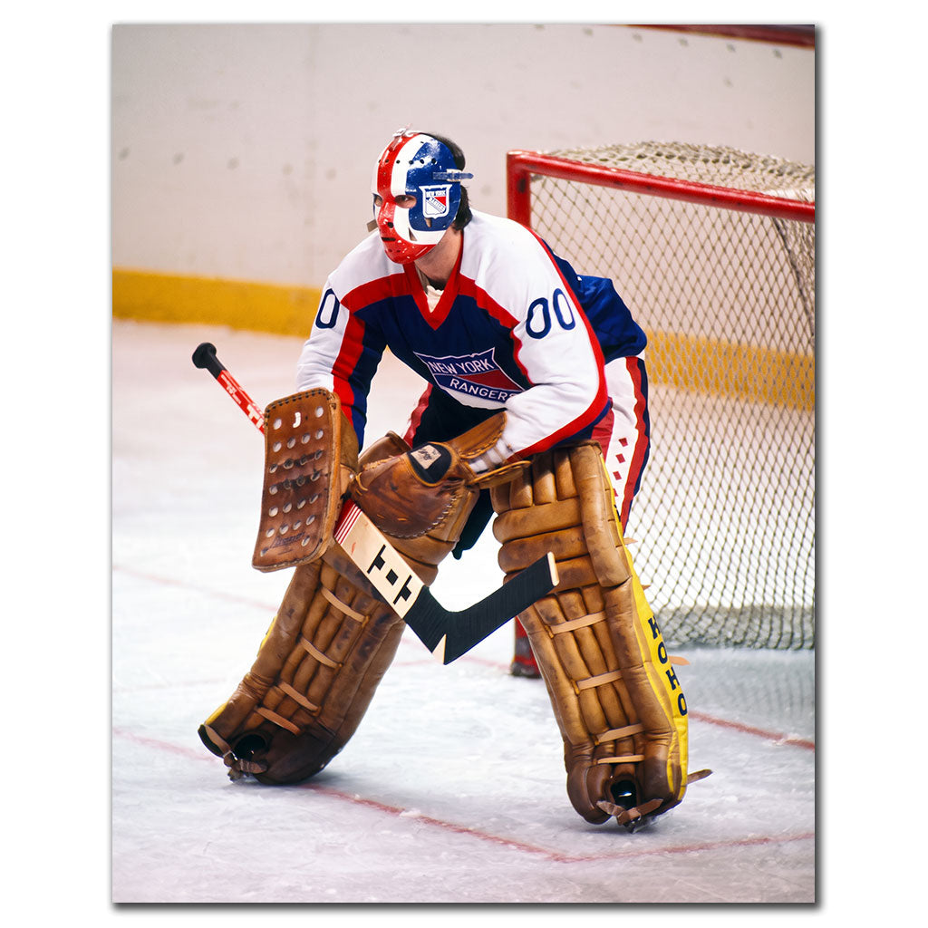 John Davidson New York Rangers 8x10 hockey photo wearing a white jersey and red, white and blue goalie mask while holding a ready stance beside the net with vintage brown pads for autograph pre-order