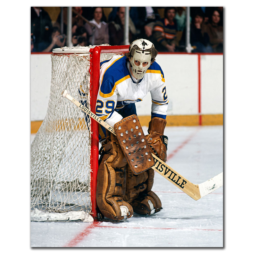 Don Edwards wearing a vintage goalie mask in a white Buffalo Sabres uniform