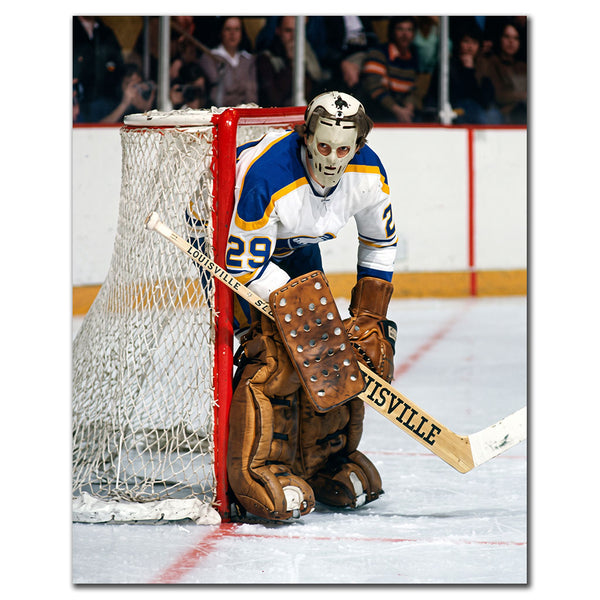 Don Edwards wearing a vintage goalie mask in a white Buffalo Sabres uniform