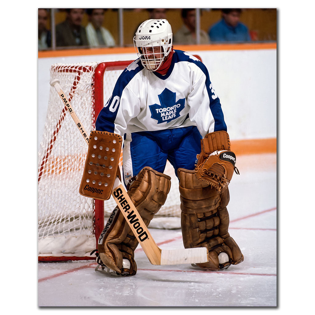 Don Edwards positioned in front of the net in a white Toronto Maple Leafs uniform