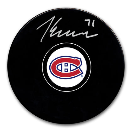 Jake Evans Autographed Montreal Canadiens official game puck, featuring a bold silver signature—perfect for fans and collectors.