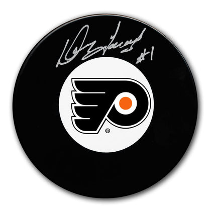 Doug Favell autographed Philadelphia Flyers black puck inscribed with “#1,” accompanied by COA; collectible sports memorabilia.