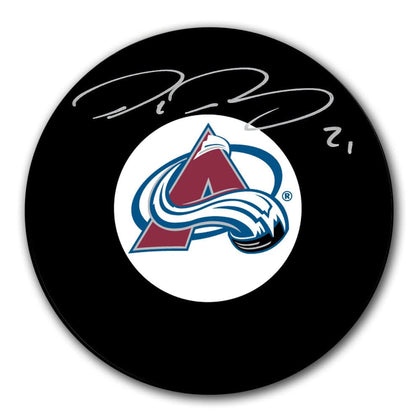 Peter Forsberg Colorado Avalanche signed hockey puck—black puck with team logo and bold silver autograph; collectible display piece.
