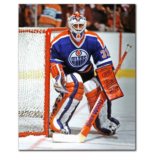 Grant Fuhr tending goal in a blue Edmonton Oilers uniform
