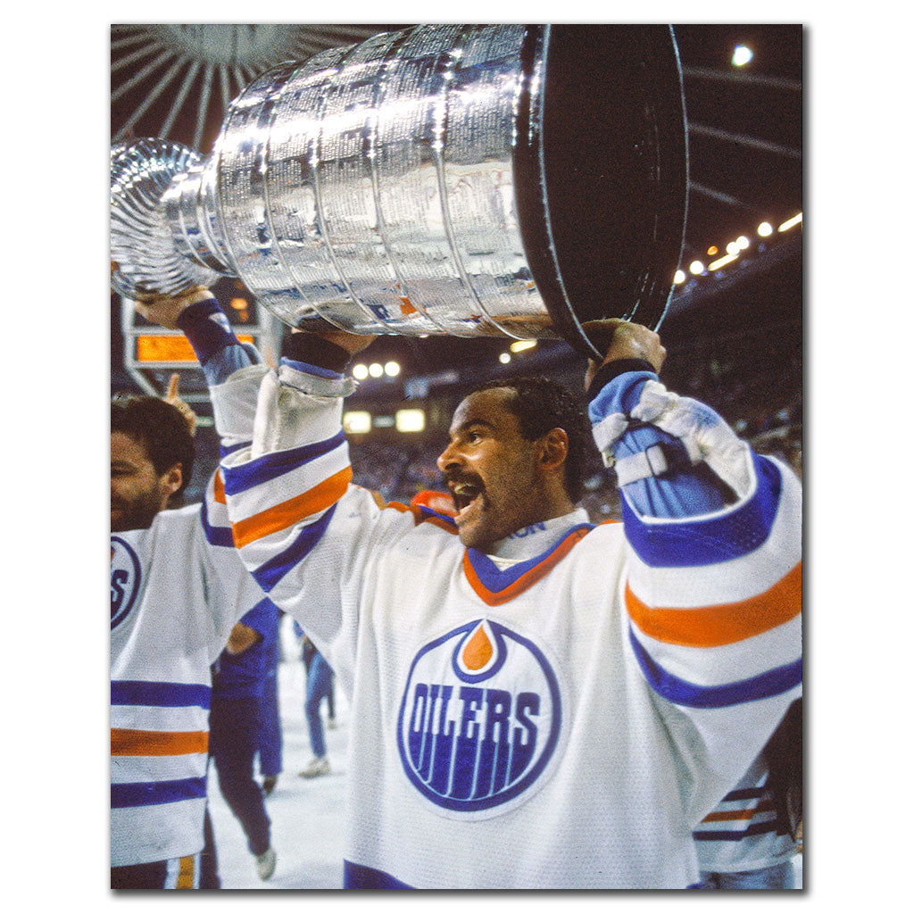 Grant Fuhr lifting the Stanley Cup in an Edmonton Oilers uniform
