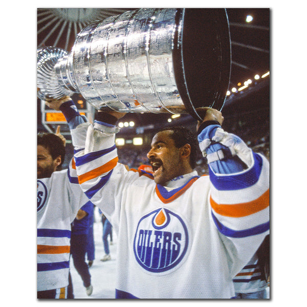 Grant Fuhr lifting the Stanley Cup in an Edmonton Oilers uniform