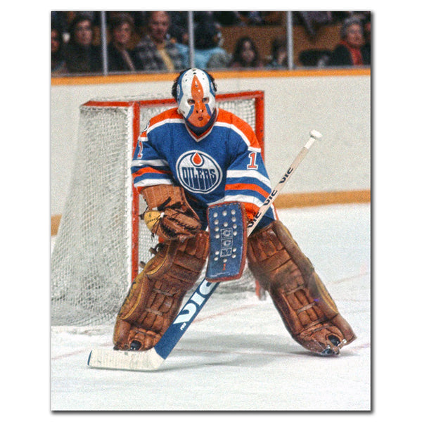 Grant Fuhr in a ready stance wearing a blue Edmonton Oilers uniform