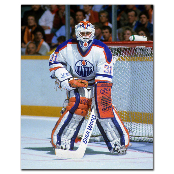 Grant Fuhr tending goal in a white Edmonton Oilers uniform