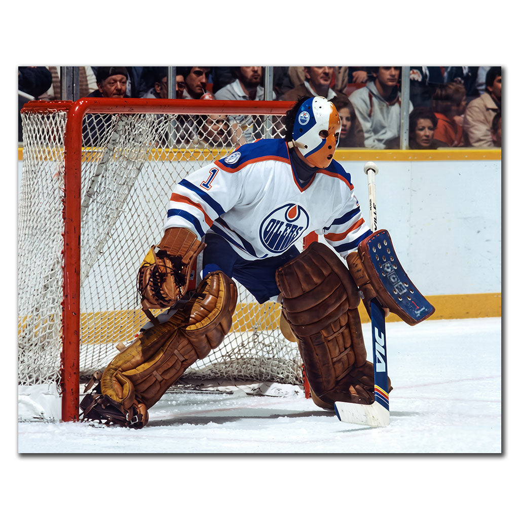 Grant Fuhr guarding the net in a white Edmonton Oilers uniform and vintage goalie mask