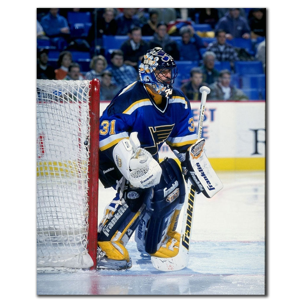 Grant Fuhr guarding the net in a dark blue St. Louis Blues uniform