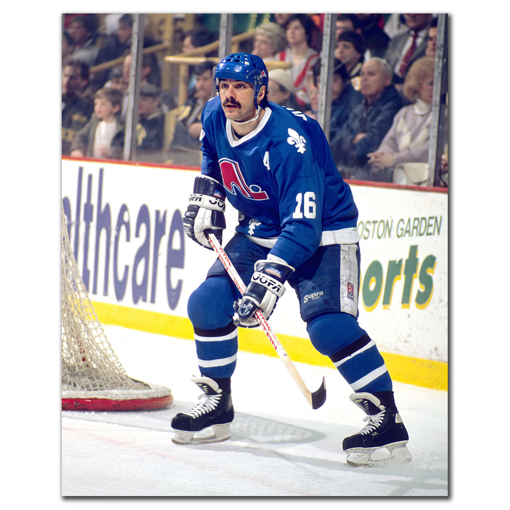Michel Goulet near the net in a blue Quebec Nordiques uniform
