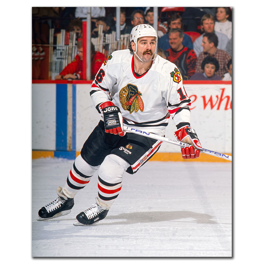 Michel Goulet skating in a white Chicago Blackhawks uniform