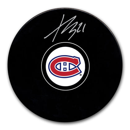 Kaiden Guhle Autographed Montreal Canadiens hockey puck featuring his signature prominently displayed on the official team puck surface.