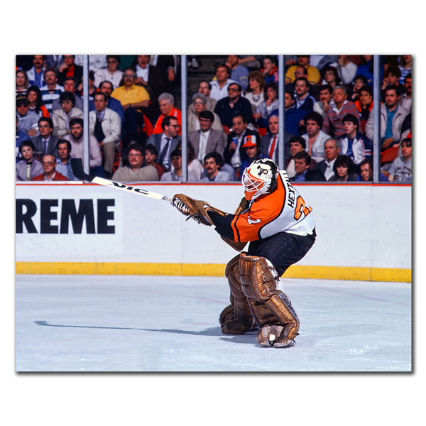 Ron Hextall Philadelphia Flyers 8x10 hockey photo in an orange goalie uniform shooting the puck during an NHL game for autograph pre-order