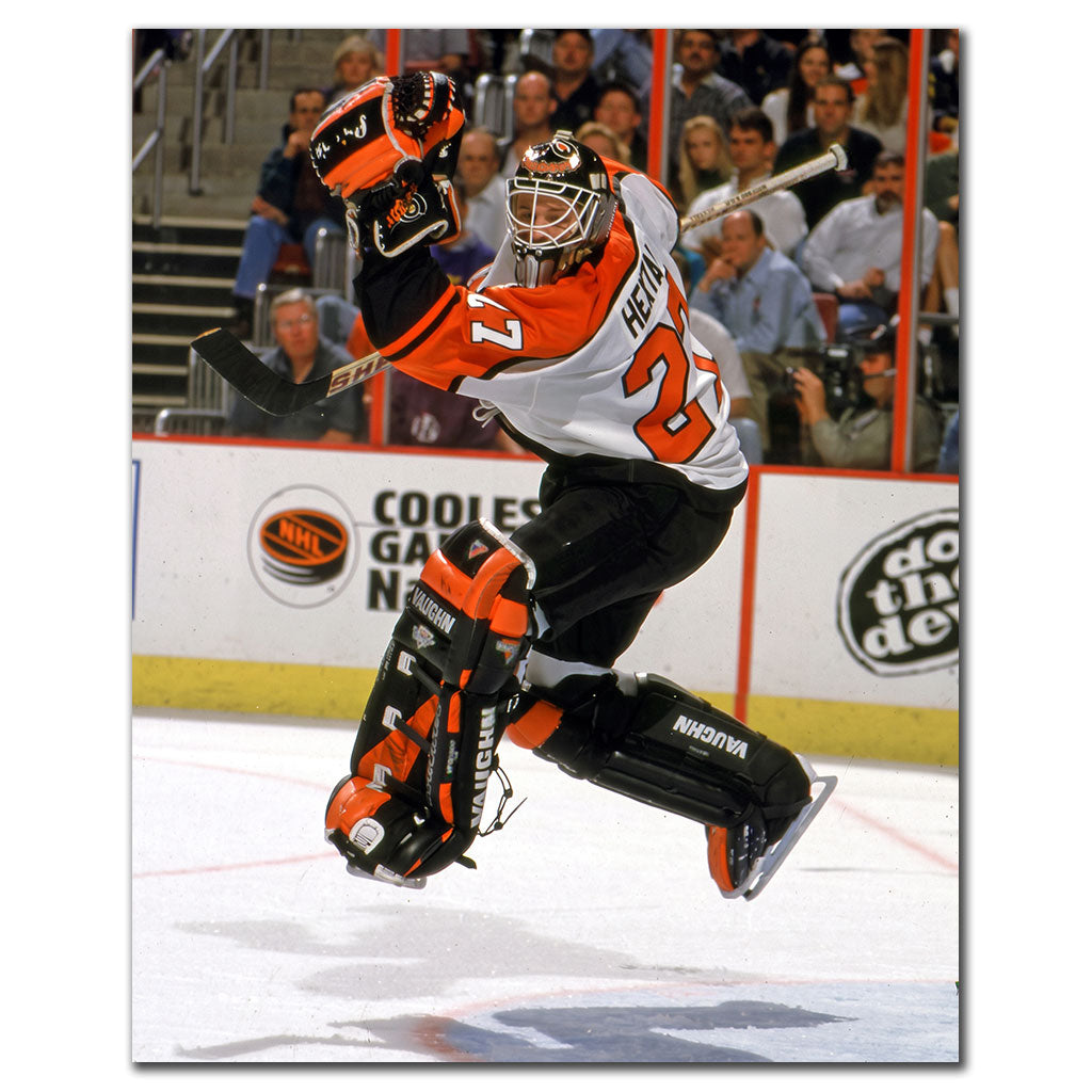 Ron Hextall Philadelphia Flyers 8x10 hockey photo in an orange goalie uniform moving across the ice during an NHL game for autograph pre-order