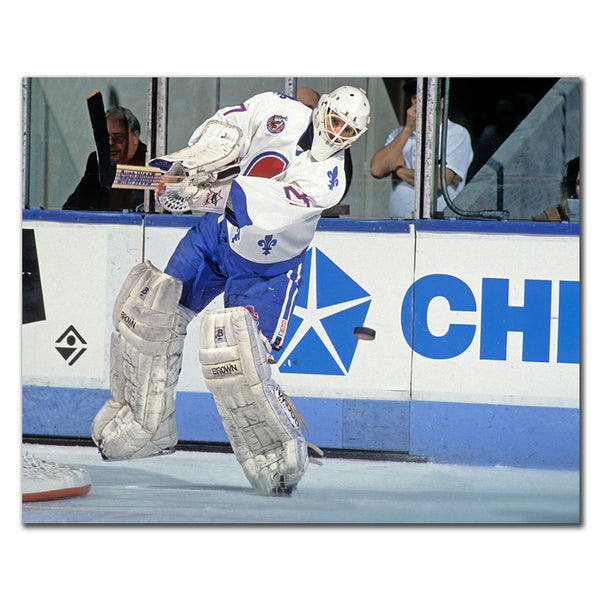Ron Hextall Quebec Nordiques 8x10 hockey photo in a white goalie uniform playing the puck for autograph pre-order