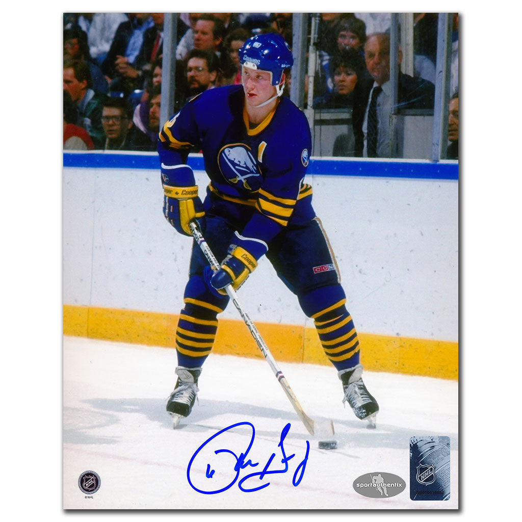 Phil Housley autographed Buffalo Sabres 8x10 photo in blue jersey skating with puck