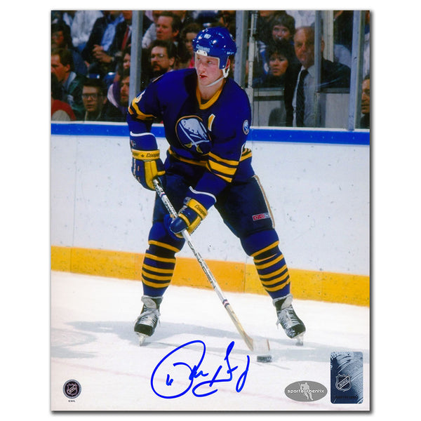 Phil Housley autographed Buffalo Sabres 8x10 photo in blue jersey skating with puck
