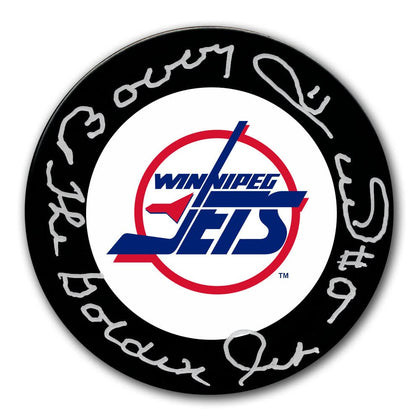 Bobby Hull The Golden Jet signed Winnipeg Jets hockey puck, featuring white autograph and bold team logo—premium memorabilia.