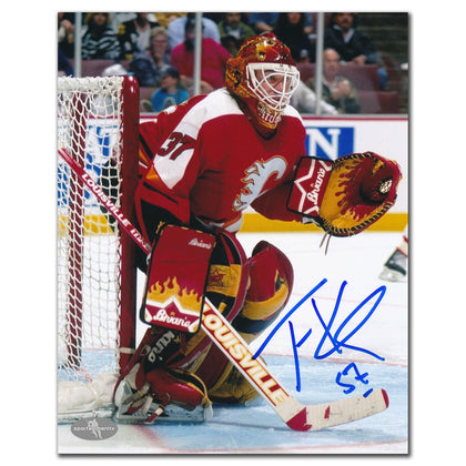 Autographed 8x10 photo of Trevor Kidd in Calgary Flames red goalie gear, featuring his bold blue signature across the front.