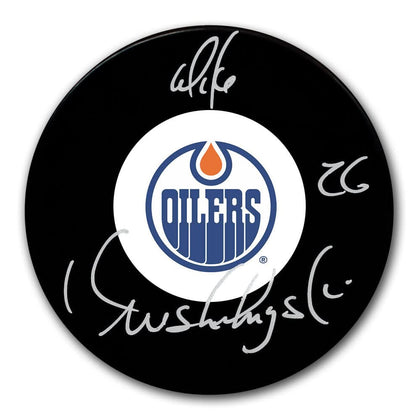 Mike Krushelnyski Edmonton Oilers signed hockey puck, featuring a silver autograph and bold team logo on collectible format.