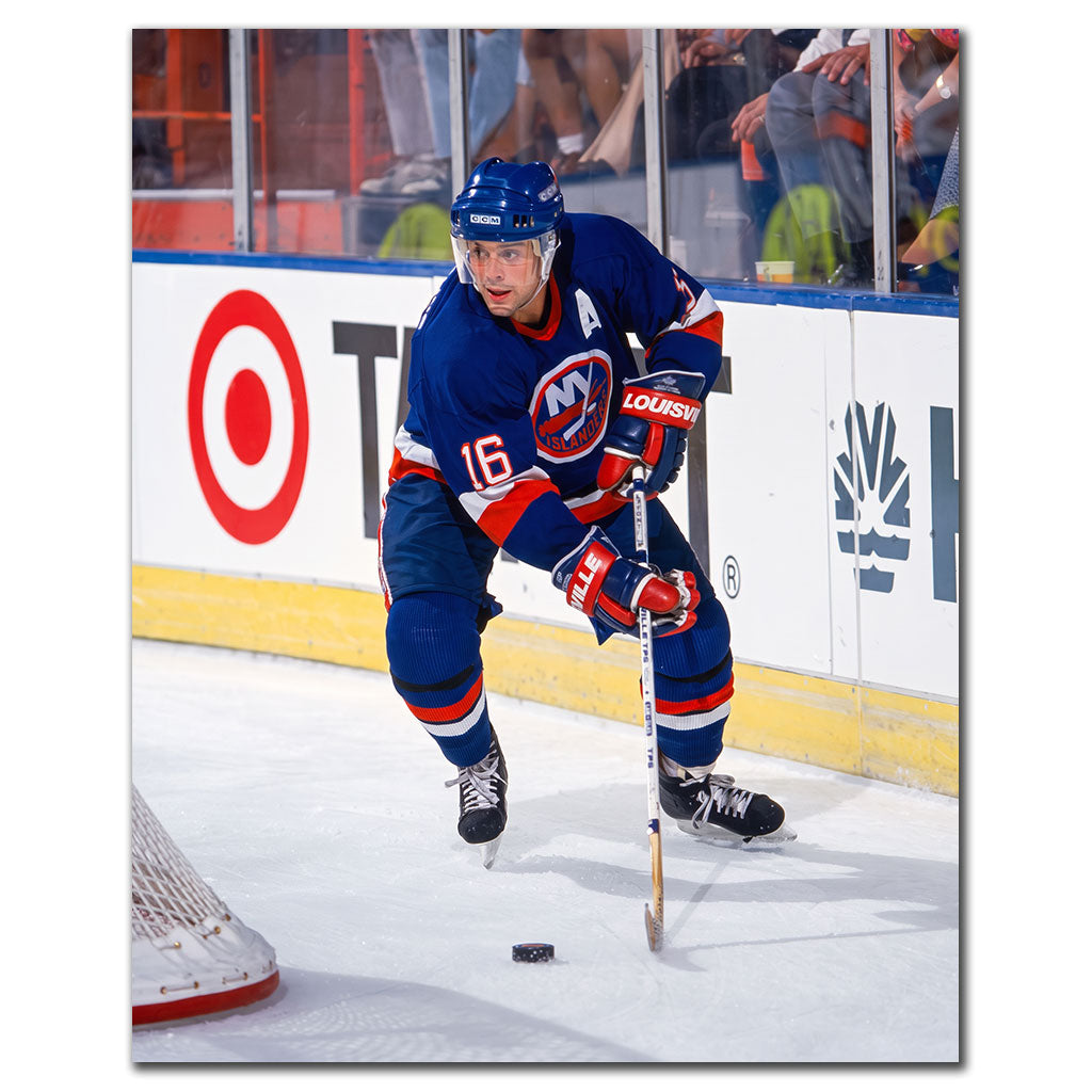 Pat LaFontaine handling the puck near the net in a blue New York Islanders uniform