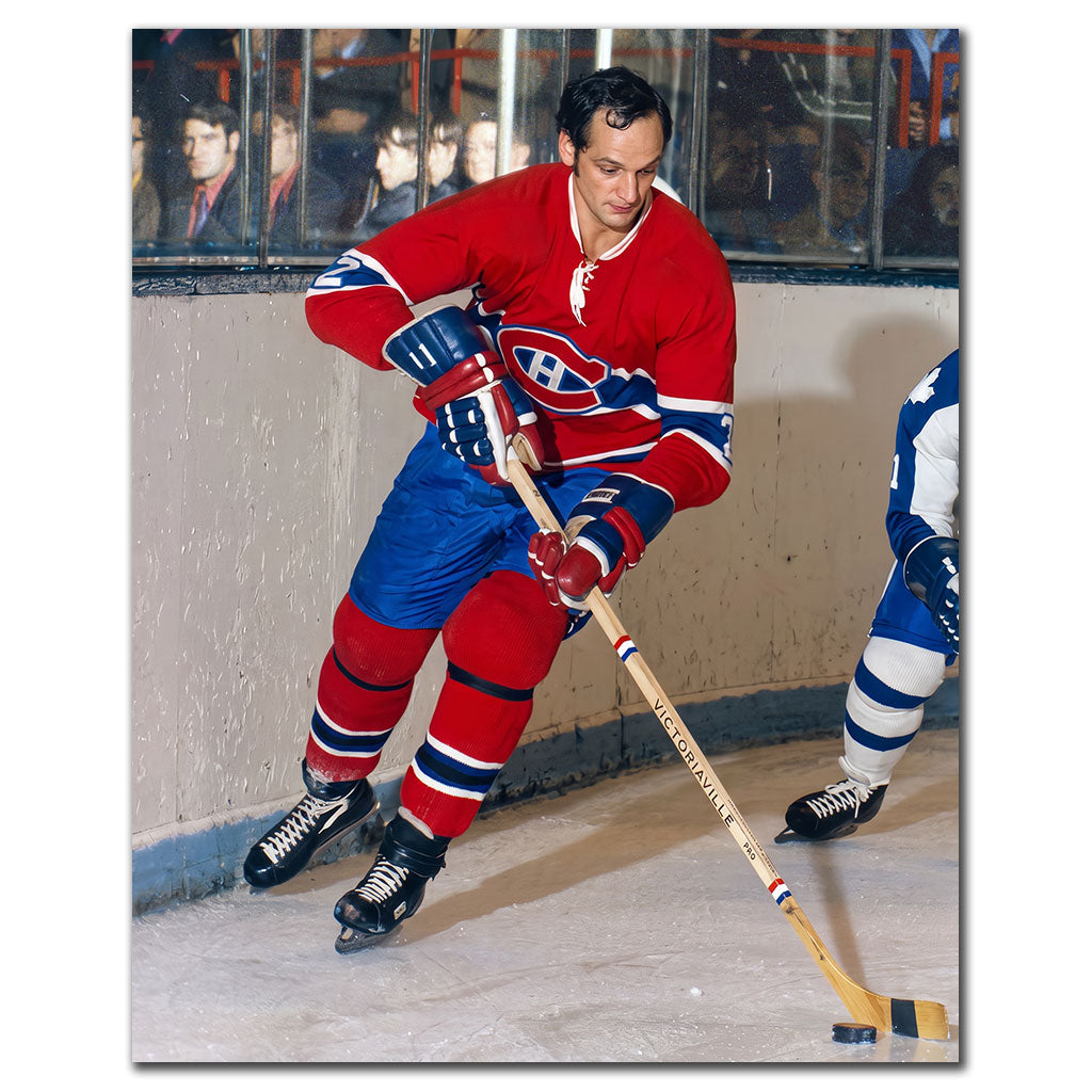 Jacques Laperriere controlling the puck in a red Montreal Canadiens jersey during a vintage NHL game