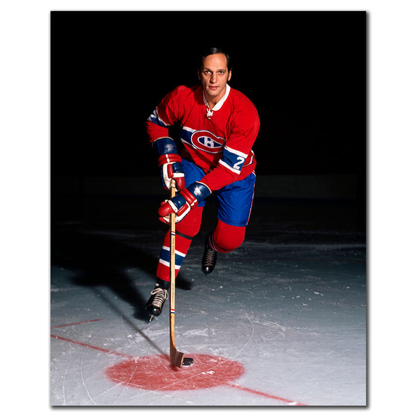 Jacques Laperriere skating toward the camera in a red Montreal Canadiens jersey against a dark arena background