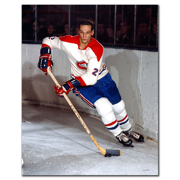 Jacques Laperriere skating with the puck in a white Montreal Canadiens jersey during a vintage NHL game