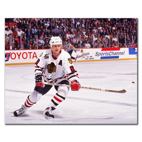 Steve Larmer skating in a white Chicago Blackhawks uniform