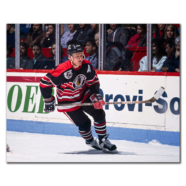 Steve Larmer skating in a black Chicago Blackhawks uniform