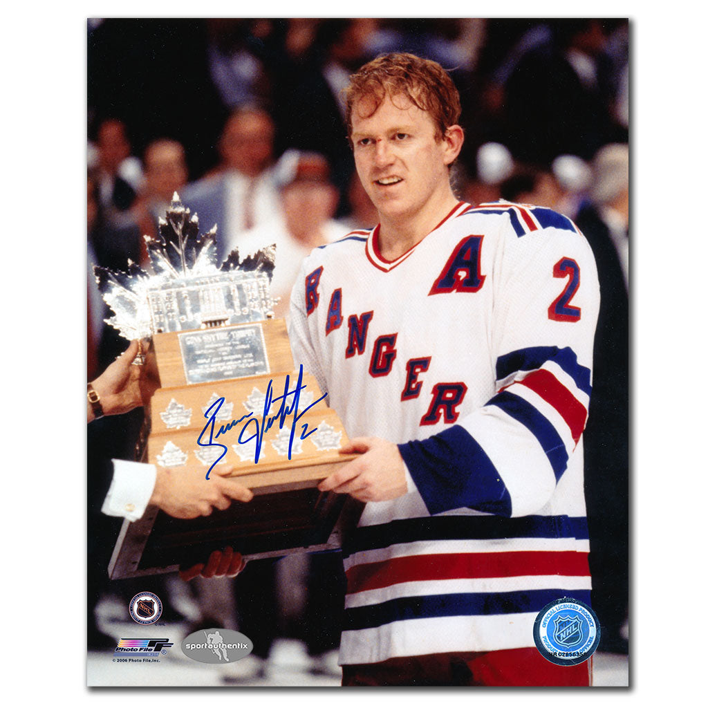 Brian Leetch autographed New York Rangers 8x10 photo holding the 1994 Conn Smythe Trophy