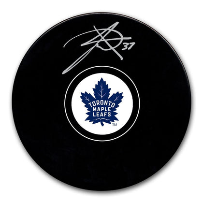 Timothy Liljegren hand-signed Toronto Maple Leafs puck (#37) with visible autograph, accompanied by Certificate of Authenticity.