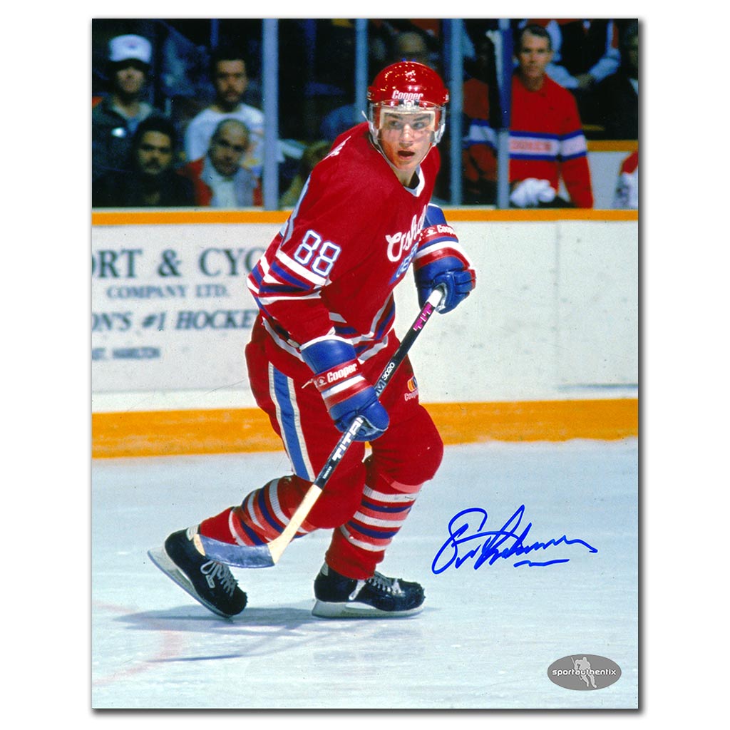 Eric Lindros autographed Oshawa Generals 8x10 photo in red jersey during junior hockey action