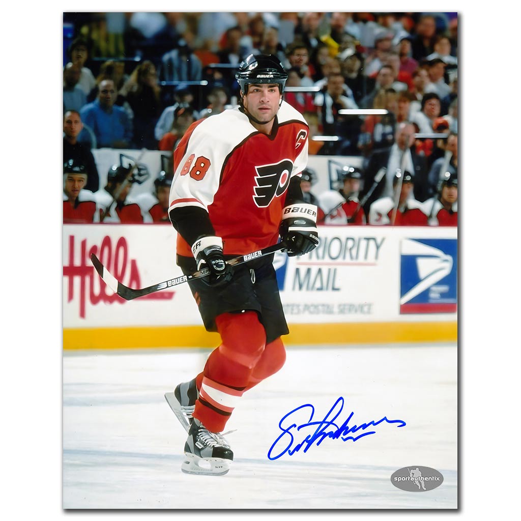 Eric Lindros autographed Philadelphia Flyers 8x10 photo in orange jersey skating on the ice