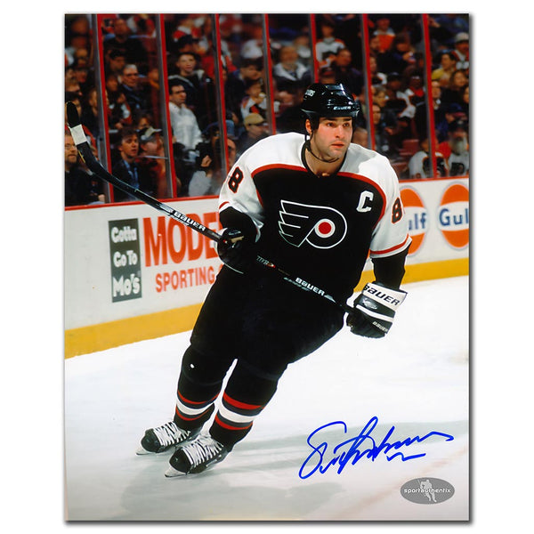 Eric Lindros autographed Philadelphia Flyers 8x10 photo in black jersey skating on the ice