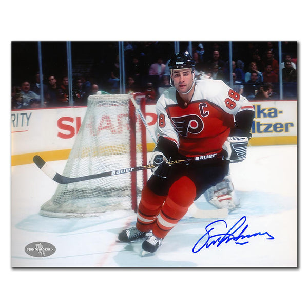 Eric Lindros autographed Philadelphia Flyers 8x10 photo in orange jersey skating around the net