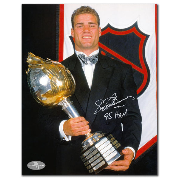 Eric Lindros autographed Philadelphia Flyers 8x10 photo holding the 1995 Hart Trophy