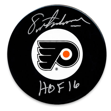 Eric Lindros autographed Philadelphia Flyers HOF puck, silver ink signature with HOF 16 inscription, collectible hockey memorabilia.