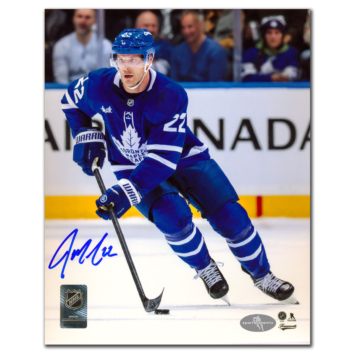 Jake McCabe autographed Toronto Maple Leafs 8x10 photo skating in blue jersey with puck