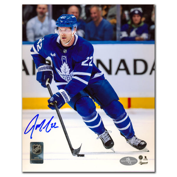 Jake McCabe autographed Toronto Maple Leafs 8x10 photo skating in blue jersey with puck