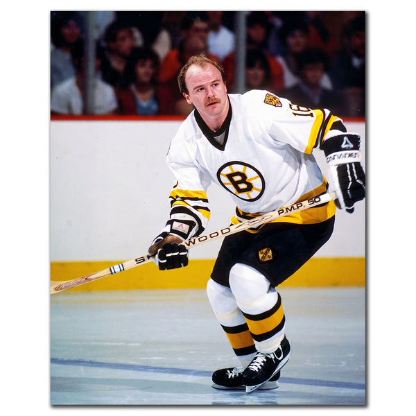 Rick Middleton skating in a white Boston Bruins uniform