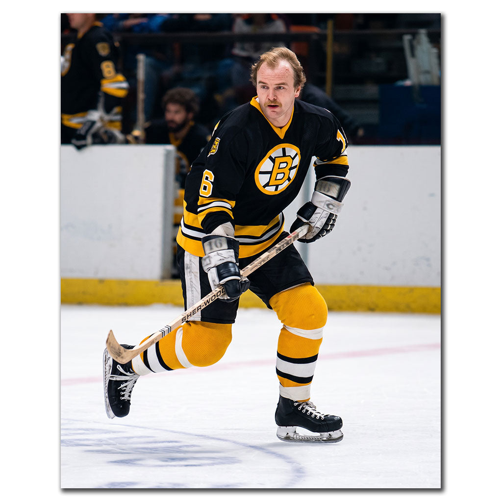 Rick Middleton skating in a black Boston Bruins uniform