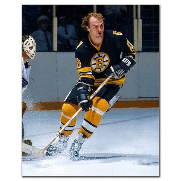 Rick Middleton carrying the puck in a black Boston Bruins uniform